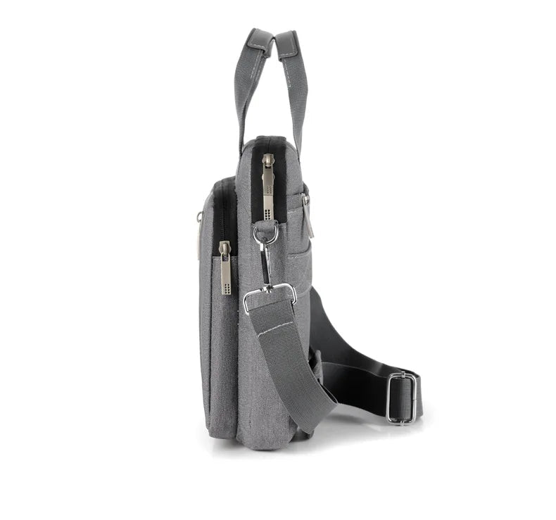 Sideview of grey crossbody bag on a white background