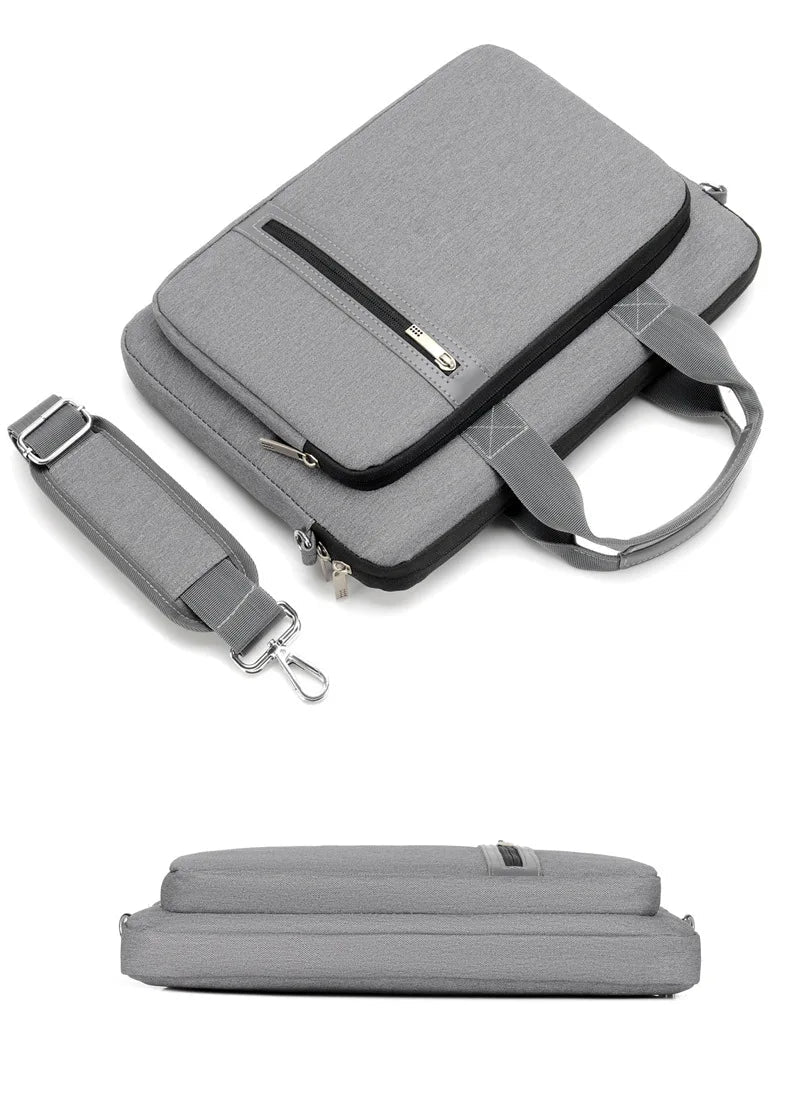 Grey laptop bag with strap and zippers on a white background