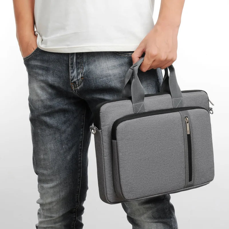 Person holding a gray laptop or macbook bag against a white background