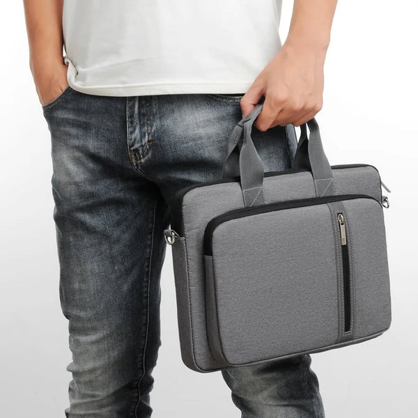 Person holding a gray laptop or macbook bag against a white background